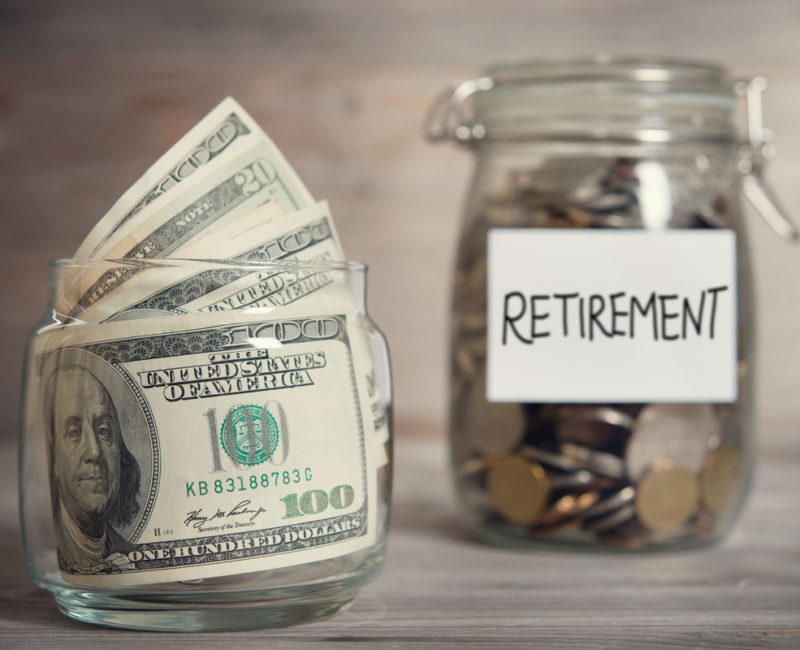 Dollar bills and coins in retirement savings jars