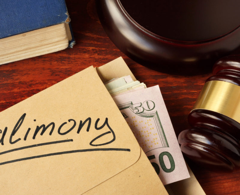 Alimony payment in an envelope on a courthouse desk