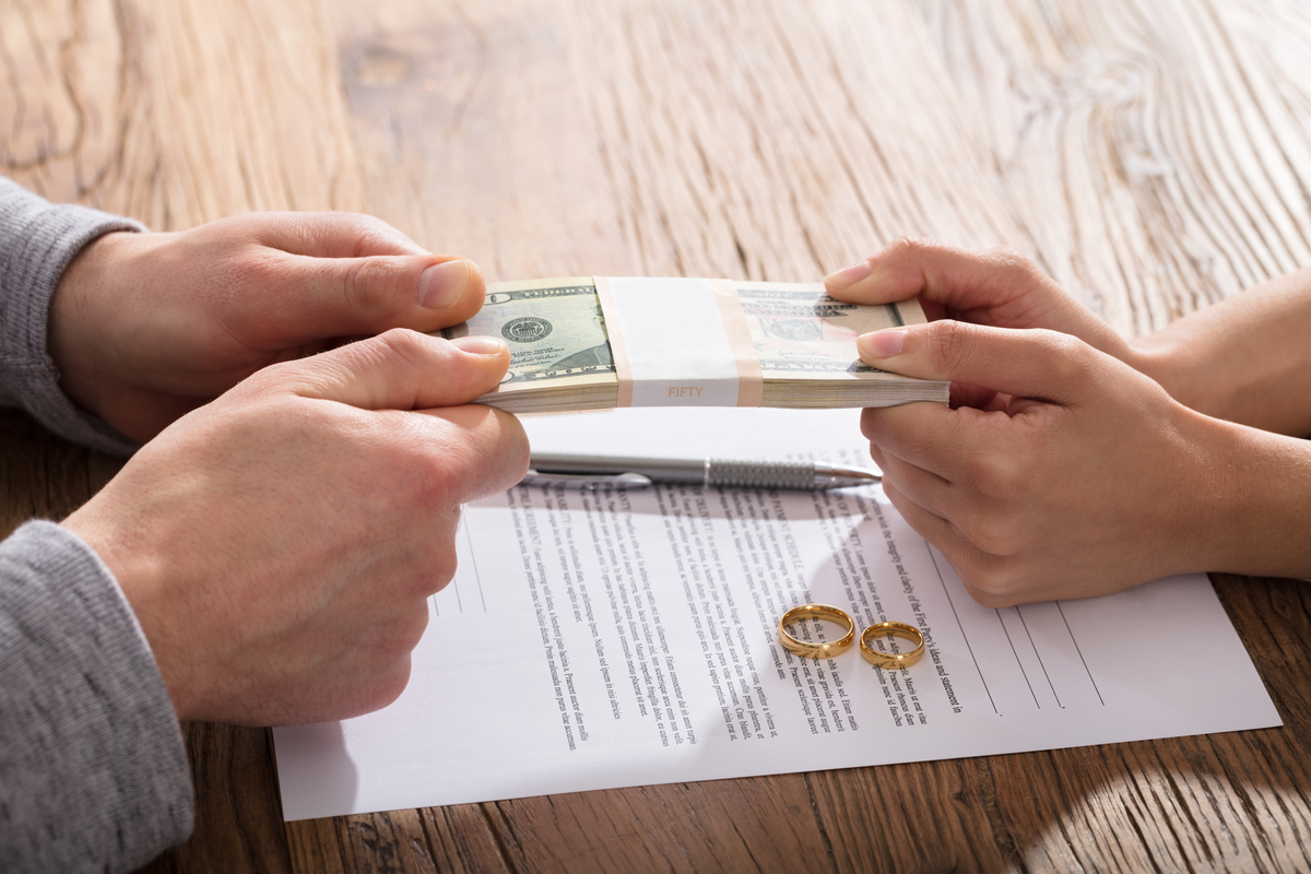 Couple fighting over money near divorce papers